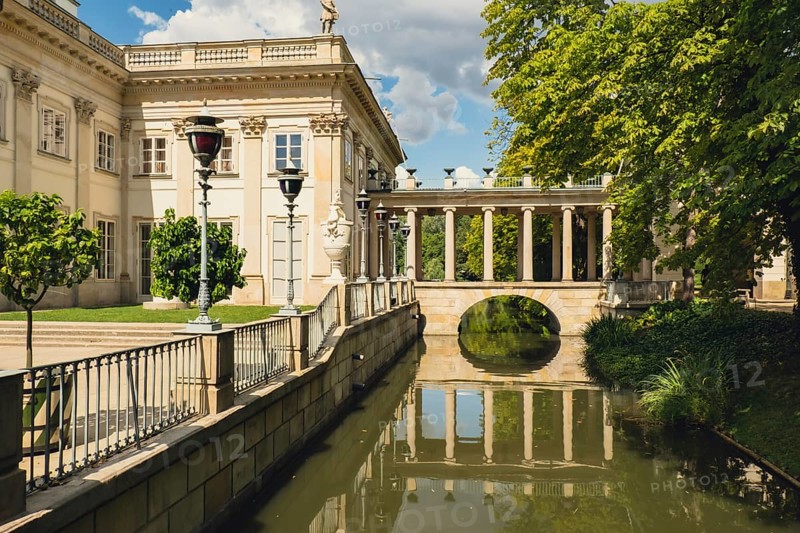 Warsaw Poland May 2022 Baths classicist Palace on the Isle in Lazienki Park touristic place in Warsaw. Lazienki Royal Baths Park. Mirror Reflection on the Lake. Nature in summer Baroque columns