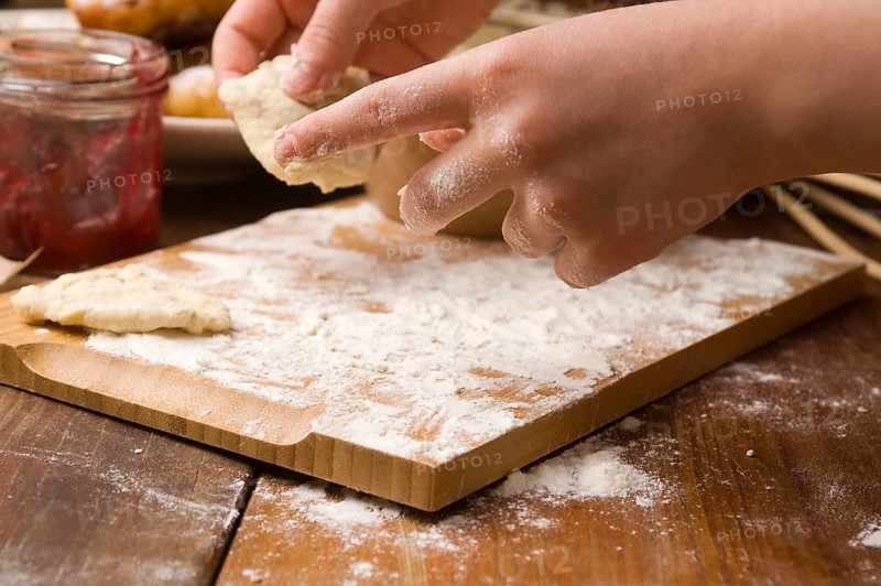 Detail of hands kneading dough, lodz, poland