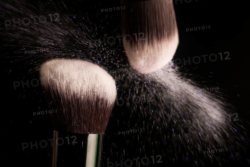 Cosmetics brush and colorful makeup powder