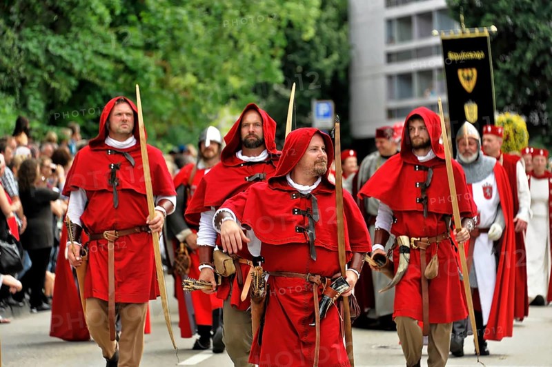 850 years of Gmünd, Schwäbisch Gmünd, Baden-Württemberg, Group of men in red medieval costumes, armed, marching on the street in a parade, 850 years of Gmünd, Schwäbisch Gmünd, Baden-Württemberg, Germany, Europe