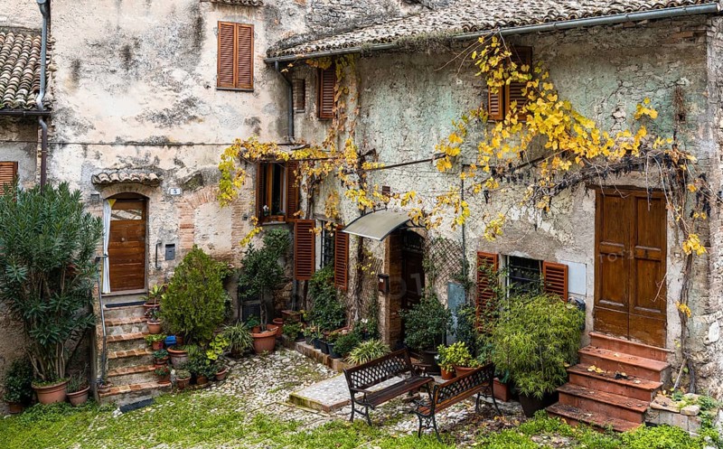 Spoleto, Italy, 25 November, 2022: rustic stone house and small backyard in the historic city center of Spoleto, Europe