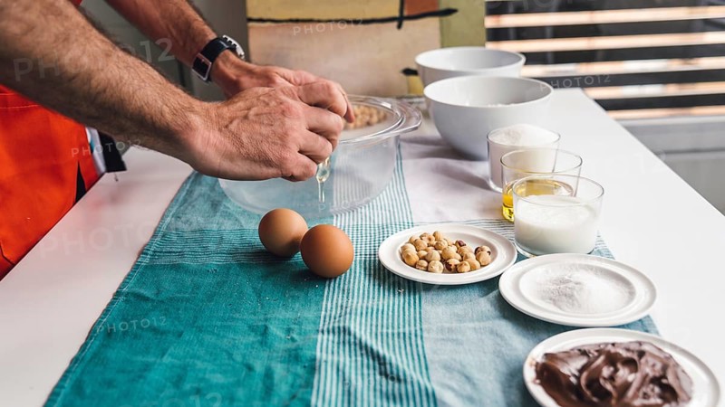 Man preparing a homemade cake with chocolate and hazelnuts