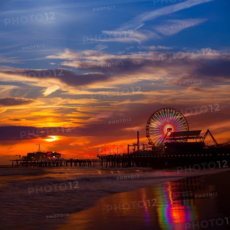 Santa Monica California sunset on Pier Ferrys wheel and reflection on beach wet sand