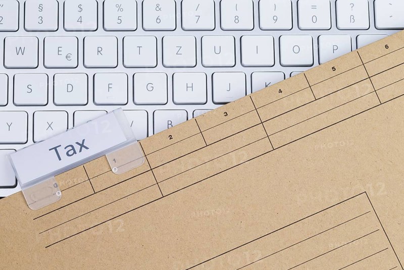 The photo shows a white keyboard with a tax briefcase