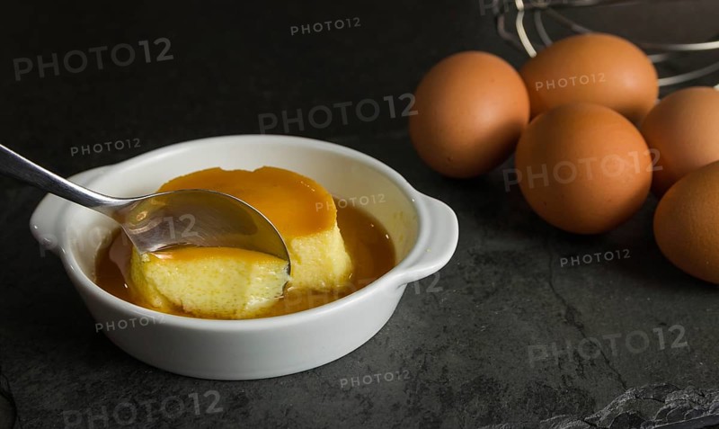 Traditional Brazilian dessert, milk pudding on dark background