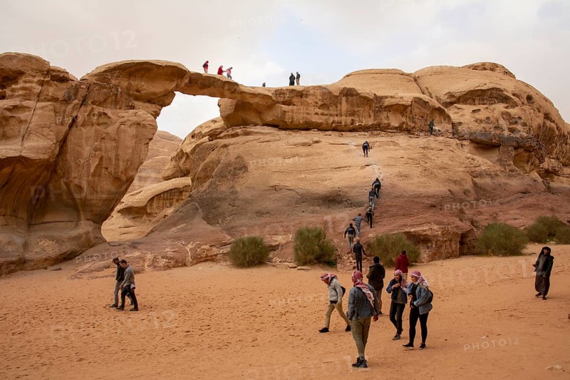 Wadi Rum, Jordan, March 2020: People, tourists, climbing the Um Frouth natural Rock Bridge, Asia