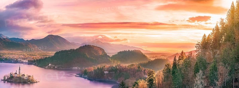 Panoramic view with the Bled island, the lake and the surrounding hills, in amazing colors due to the sunrise. Slovenia is a wonderful place to visit