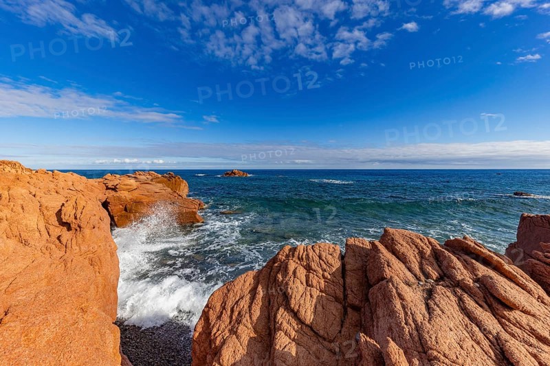 Coastal landscape with red rocks and surf in blue sky and sunshine, Spiaggia di Cala E'Luas, Ogliastra, Sardinia, Italy, Europe