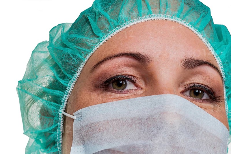 A nurse or doctor in surgical clothing in front of an operation. Symbolic photo for stress and overtime in hospital. Austria