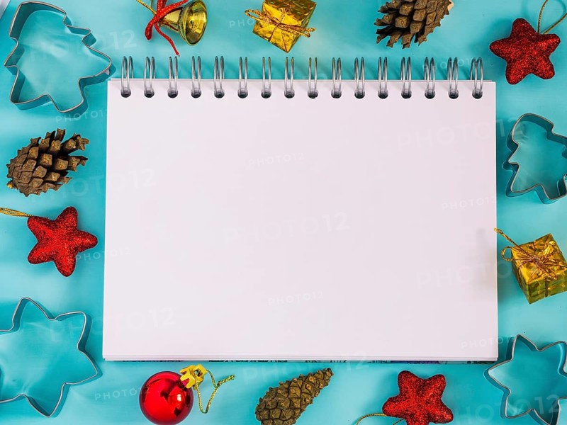 Christmas background with blank notebook, decorations. Copy space. Top view or flat lay. Toned image