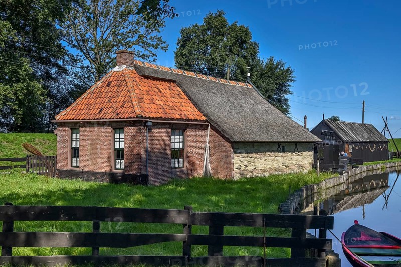 Enkhuizen, the Netherlands, September 2020. The Zuiderzeemuseum, an open air museum at the shore of the IJsselmeer with traditional Dutch fishermen cottages and flat bottomed fishing boats.