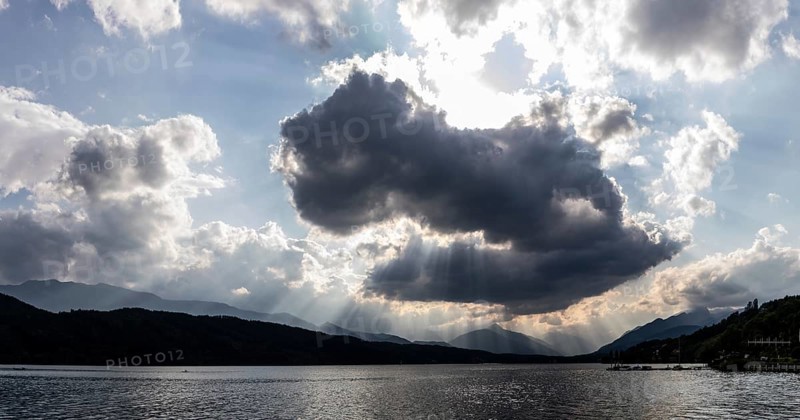 Cloudy mood over Lake Millstättersee, sunbeams from clouds, near Millstatt, Carinthia. Austria