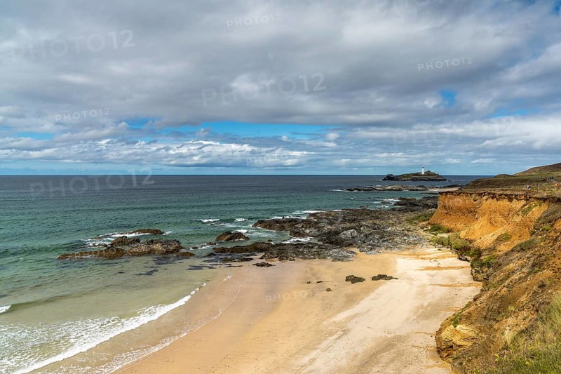 View of St. Ives Bay in Cornwall and small beach near Gwithian with the Godrevy Lighthouse in the background