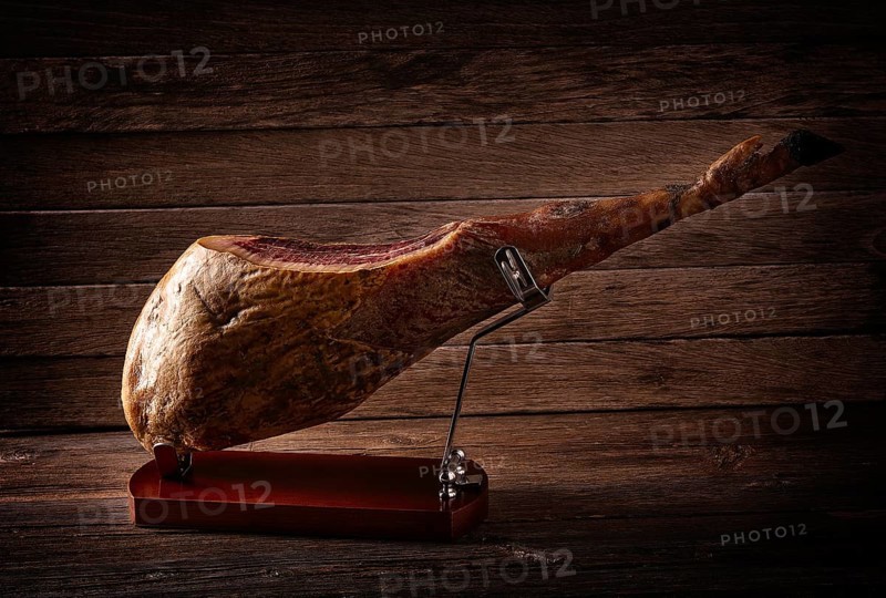 Iberian ham pata negra from Spain on wood background