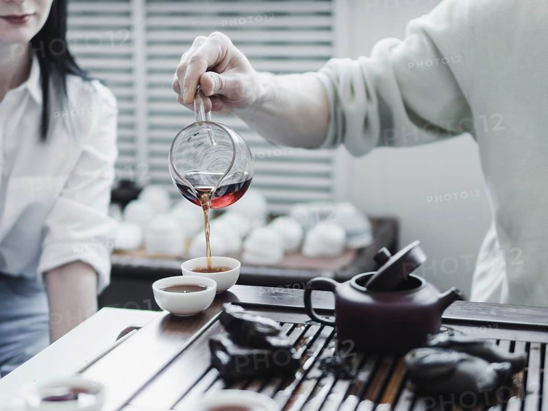 Chinese tea ceremony. Master pouring puer tea in cups. Pu erh tea ceremony