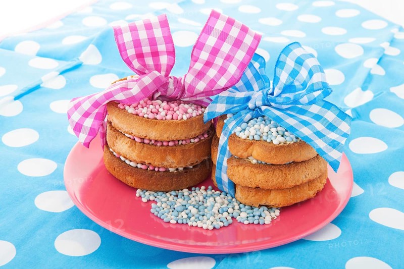Dutch tradition with pink mice on biscuit while baby born isolated over white background