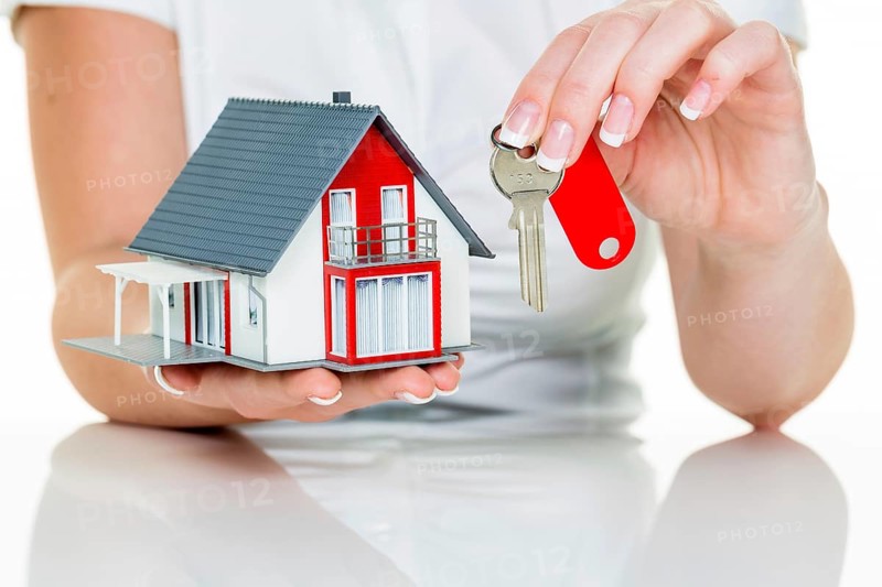 A real estate agent for properties with a house and a key Successful letting and house sales by real estate agents. Austria