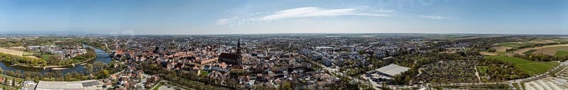 Panoramic view of a large city with river (Danube), red roofs and extensive landscape under a blue sky with few clouds, Straubing, Lower Bavaria