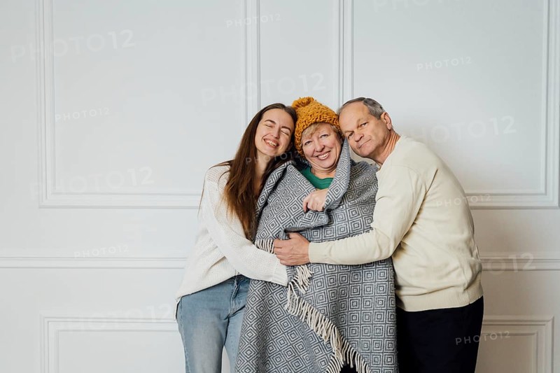 Close up portrait of family with elderly mature woman, man and millennial daughter.