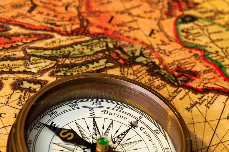 An old compass lies on a map of Austria