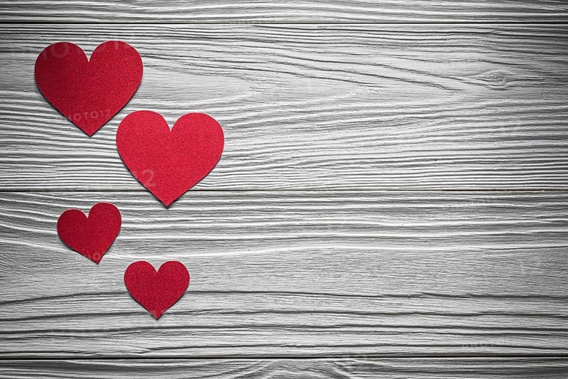 Red paper hearts on wooden board Valentine cards