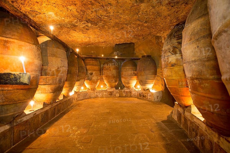 Antique winery in Spain with clay vessels terracotta amphora pots Mediterranean tradition with candlelight