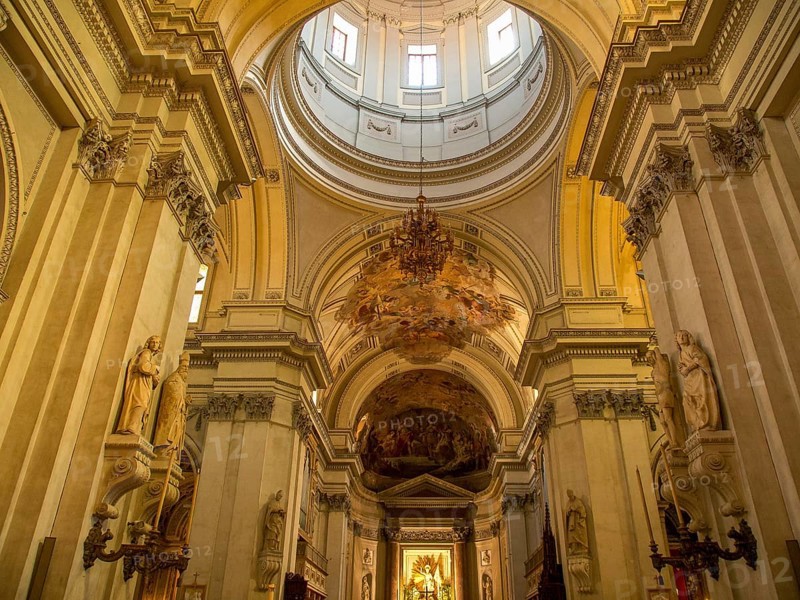 Impressive interior view of a baroque church with high columns and ornate frescoes on the ceiling, montserrat, spain