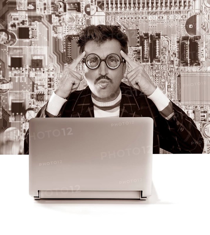 Nerd pensive man with myopic glasses looking for solution on electronics technology problem