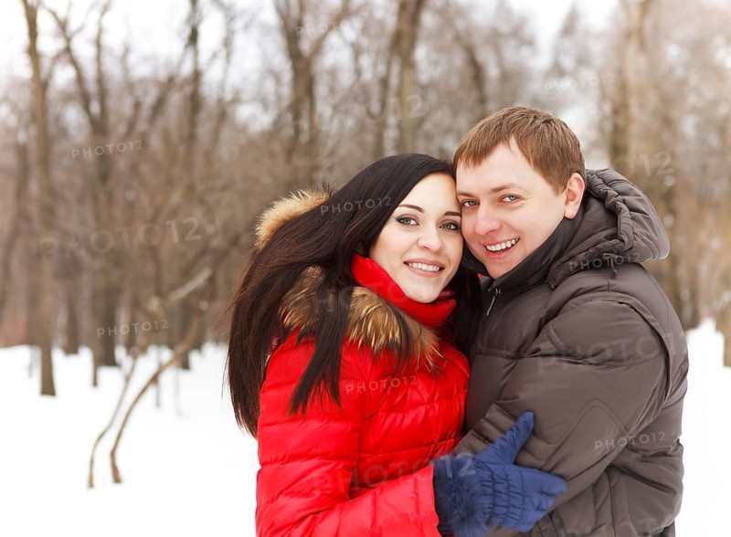 Happy young couple having fun in the winter park