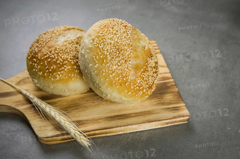 Beautiful Sourdough bread on gray background with dried wheat flower