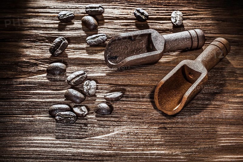 Coffee crops in scoop on vintage wooden board