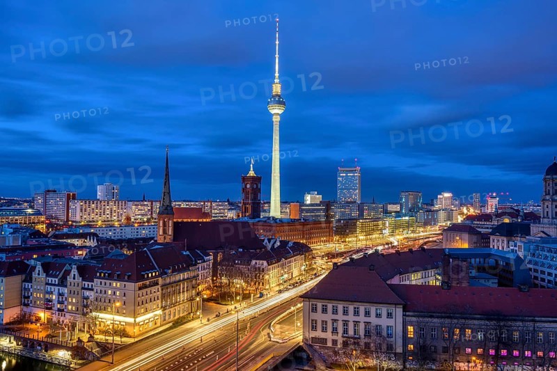 The centre of Berlin with the famous television tower and a cloudy sky at night