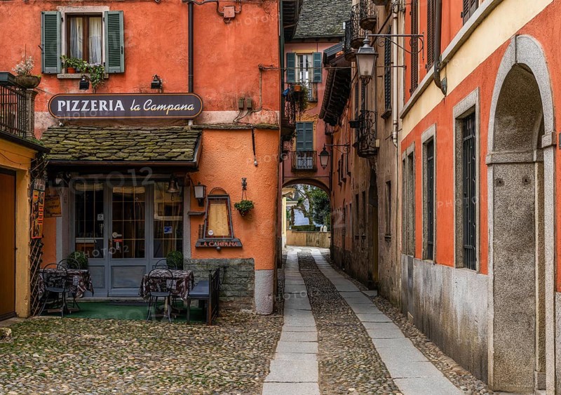 Orta San Giulio, Italy, 13 March, 2023: colorful shabby buildings in the old town center of Orta San Giulio, Europe