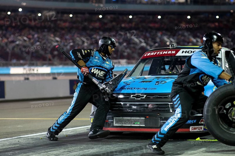The crew of Niece Motorsports work on the car prior to performs a pit stop on pit road during the Craftsman 150 at the Phoenix Raceway in Avondale AZ