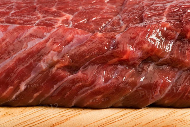Raw beef steak meat on kitchen board close up