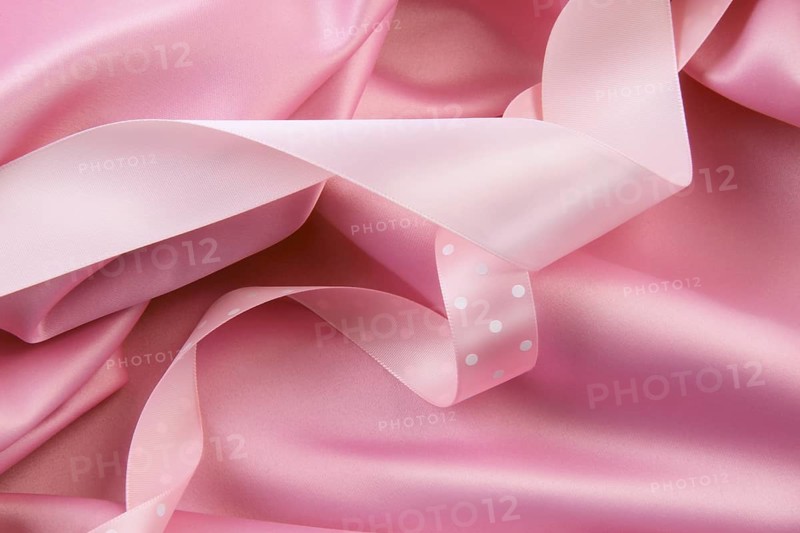 Pink satin silk background with colored ribbons