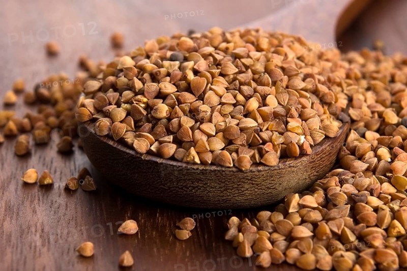 Buckwheat seeds on wooden spoon in closeup, lodz, poland