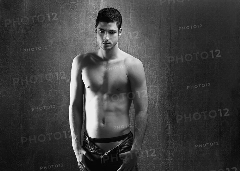 Black and white sexy young denim shirtless man on retro grunge background