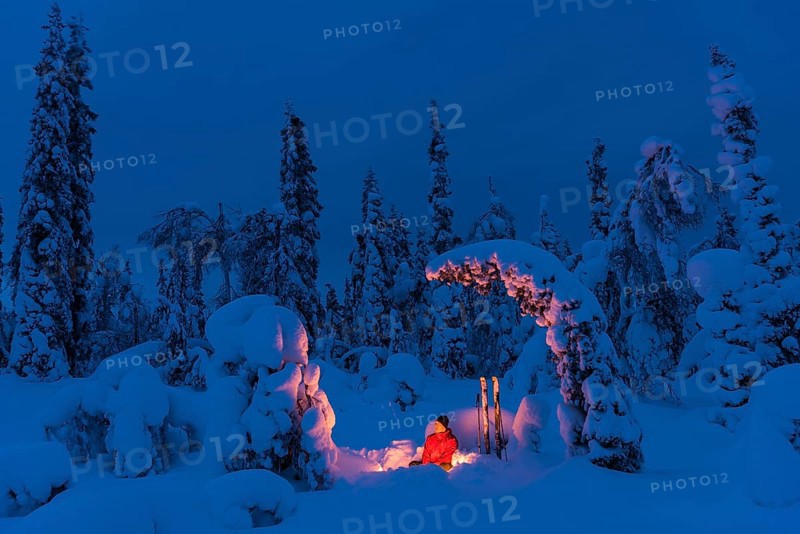Man around a campfire, Muddus National Park, Laponia World Heritage Site, Norrbotten, Lapland, Sweden, January 2016, Europe
