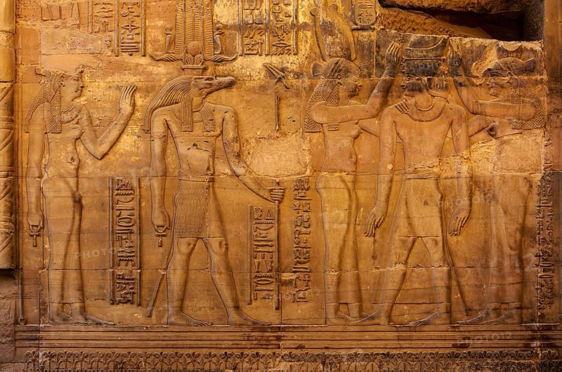 Hieroglyphic carvings on the exterior walls of an ancient egyptian temple