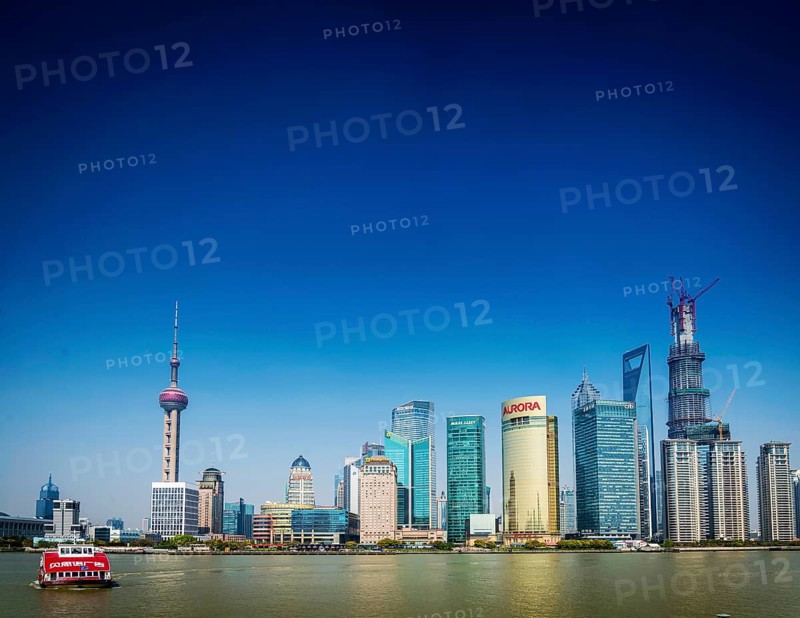 Shanghai pudong city skyline and local river ferry boat in china