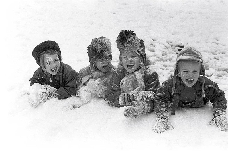 Winter in the 1950s. Children are playing in a park in Stockholm. They don't seem to be freezing. Sweden 1954. Ref 2A-14