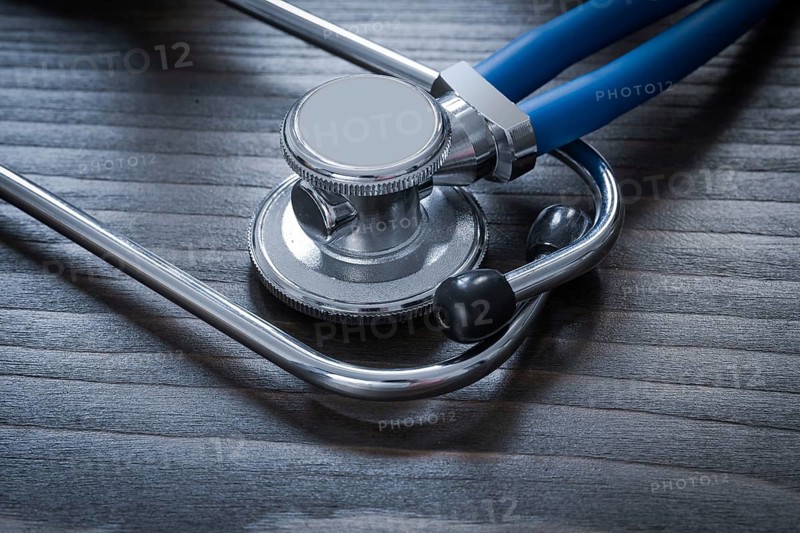 Wooden board with diagnostic medical stethoscope close up image medicine concept