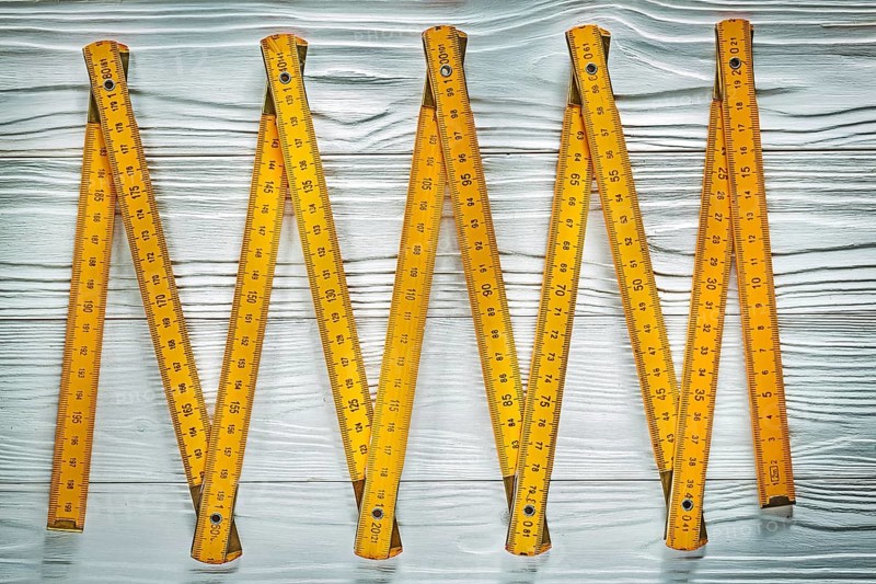 Yellow wooden meter on white board