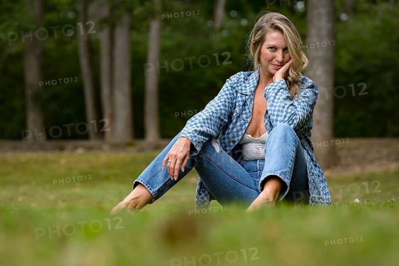 A beautiful blonde model enjoys the late summer sun outdoors. Surrounded by lush greenery and soft sunlight, she radiates warmth and elegance in the serene, golden light, Nashville, United States of America