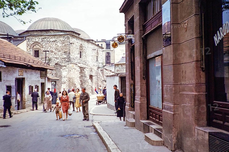 People walking along street of shops, next to domes of Brusa Bezistan museum, Sarajevo, Bosnia and Herzegovina, former Yugoslavia, Europe 1960, Europe