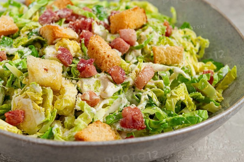 Brussels sprouts Caesar salad, with bacon and croutons, healthy food, homemade, no people