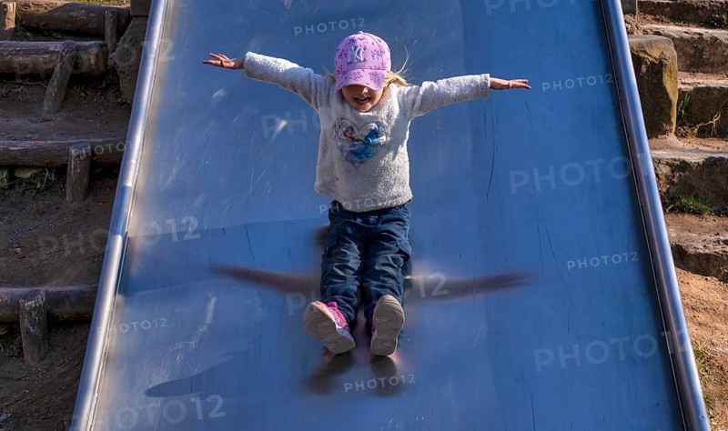 Little girl, 3 years, blonde, baseball cap, logo NYY New York Yankees, jumper, Disney, Elsa, Ice Queen, slides on slide, playground, Stuttgart, Baden-Württemberg, Germany, Europe