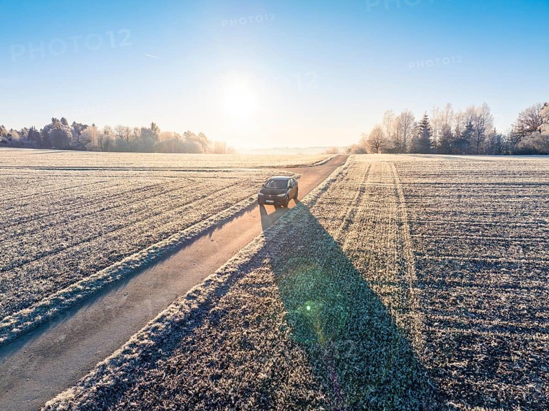 An SUV drives along a frosty country road in the winter morning light, Car Sharing, Electric car, Volkswagen ID 5, Gechingen, Hecken und Gäu Region, Black Forest, Germany, Europe