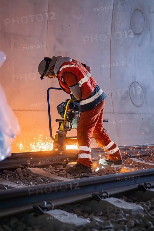 A worker grinding rails in a tunnel, sparks spraying, rail welding, track construction Hermann Hessebahn, Calw, Black Forest, Germany, Europe